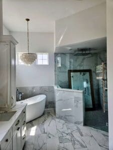 Luxurious marble tiled bathroom with white painted walls and walk-in shower