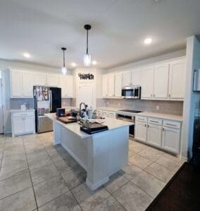 All white kitchen cabinets, countertop and island