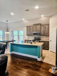 Light blue island with light grey kitchen cabinets