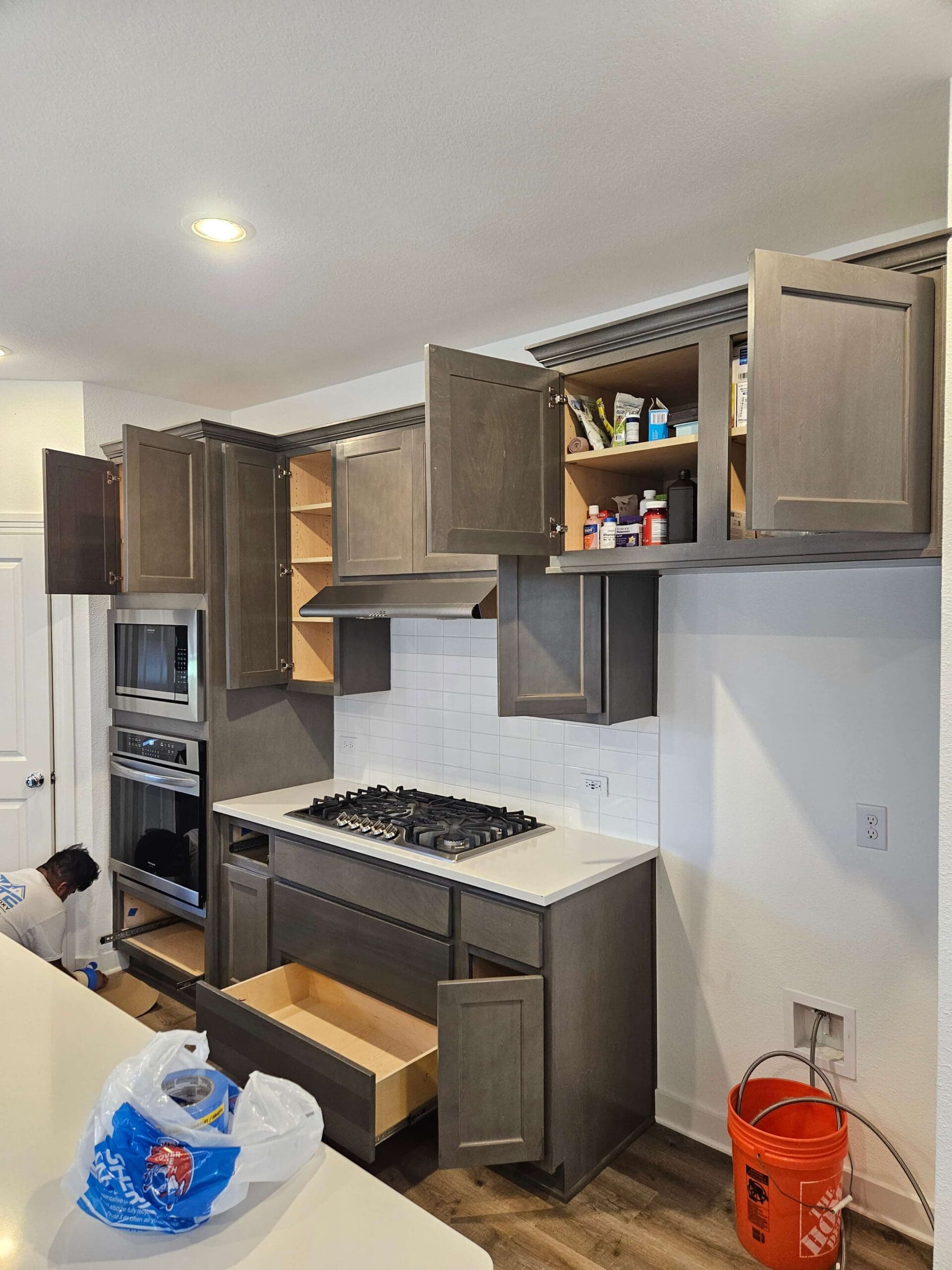 Grey kitchen cabinets against white painted walls