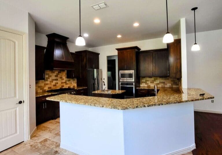 Kitchen with dark brown cabinets and granite countertops